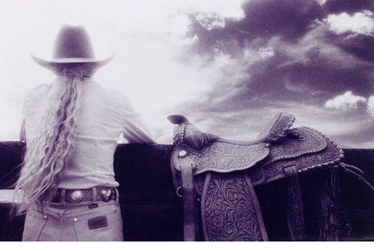 Photo of Cowgirl, Saddle and Fence